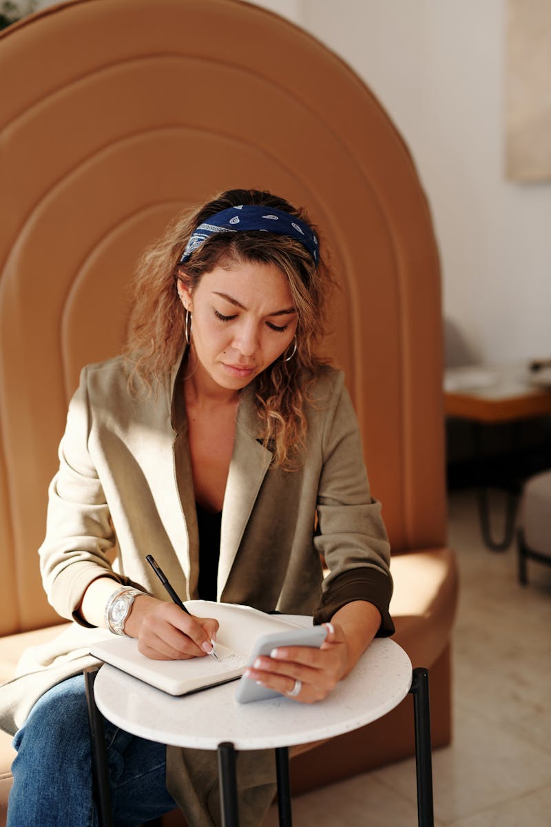 Woman in Brown Blazer Sitting on Chair