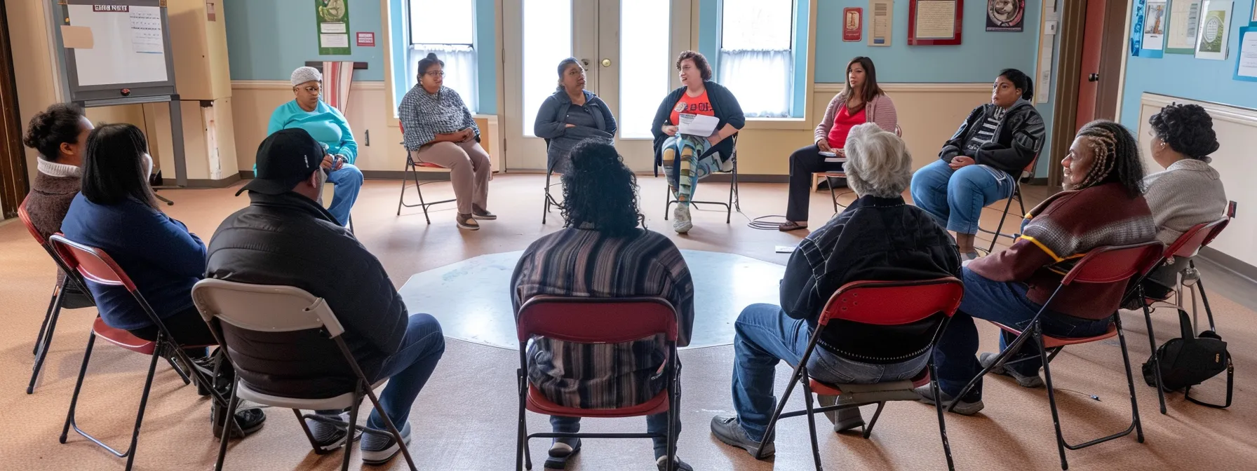 a person sitting in a circle surrounded by diverse supportive individuals, sharing stories and offering comfort during a ptsd recovery support group meeting.