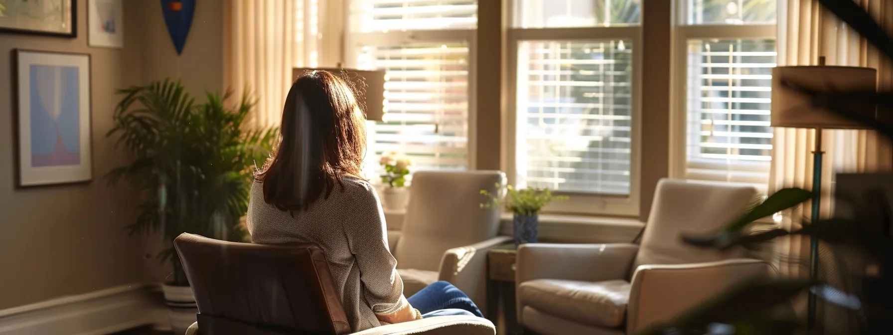 seeking professional help: a person sitting in a peaceful therapist's office, surrounded by calming decor and listening intently as the counselor offers support and guidance.