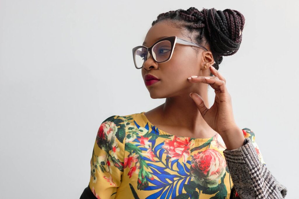 mental health therapy. Elegant portrait featuring a woman in glasses with braided hairstyle and floral top.